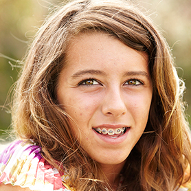 A young teenage girl with braces